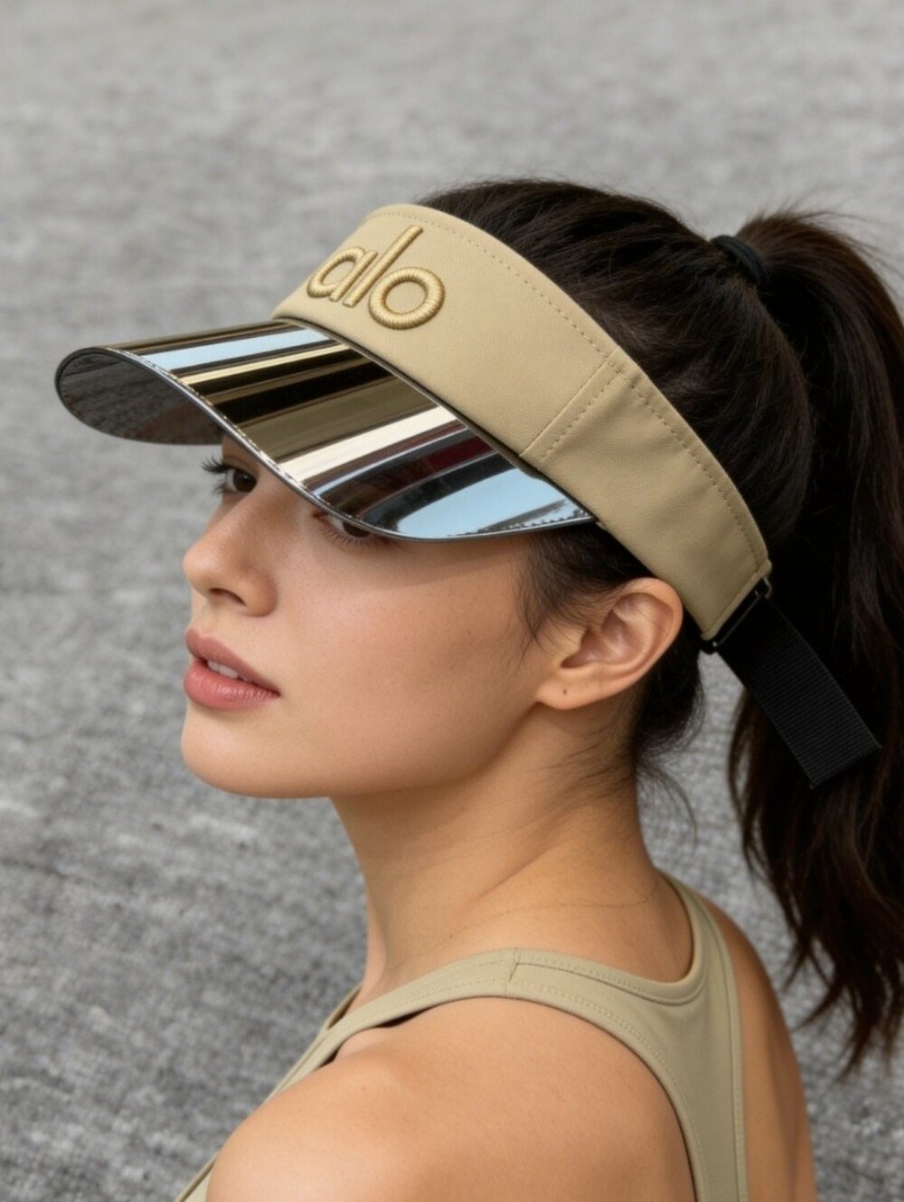 alo Yoga Airlift Solar Visor in a beige color featuring a stiff, holographic bri